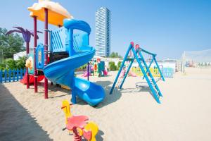 a group of playground equipment on the beach at Hotel Atlantica in Cesenatico
