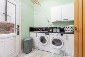 a white laundry room with a washer and dryer at Rothiemay House - Donnini Deluxe in Prestwick
