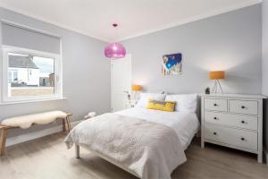 a white bedroom with a bed and a window at Rothiemay House - Donnini Deluxe in Prestwick