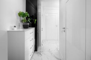 ミエルノにあるApartament Clipperの白いバスルーム(ドレッサー上の植物付) +13枚の写真