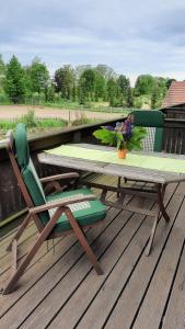 einen Tisch und einen Stuhl auf einer Terrasse in der Unterkunft Schönermarker Pferdeparadies in Niederlandin