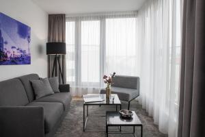 a living room with a couch and a table at AMANO HOME Apartments in Berlin +28 photos