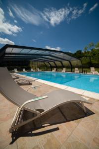 a swimming pool with a chair in front of it at La Foresteria di San Leo in Trivigno