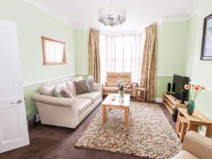 a living room with a couch and a table at Oakhurst in Keswick