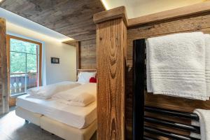 Postel nebo postele na pokoji v ubytování Hotel Majon Miramonti