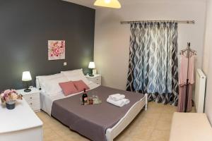 a bedroom with a bed with a bottle of wine on it at Vasso's cozy and comfortable apartment in Preveza