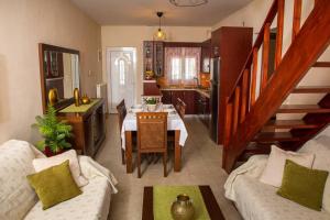 a living room with a dining table and a kitchen at Vasso's cozy and comfortable apartment in Preveza