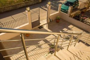 an overhead view of a balcony with stairs and flowers at Vasso's cozy and comfortable apartment in Preveza