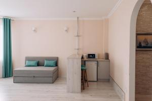 a living room with a bed and a table at Hotel DA NONNA in Odesa