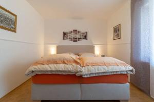 a bedroom with a bed in the corner of a room at Tuffsteinquartier am Brückenbach in Weibern