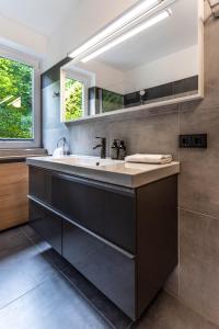 a bathroom with a sink and a mirror at Apartment Tauernfex Kaprun in Kaprun