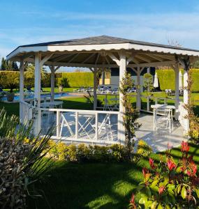 a pavilion with a table and chairs in a garden at Moya Urla Butik Otel in Izmir