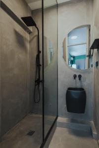 a bathroom with a sink and a mirror at K-Houses B2 in Arta