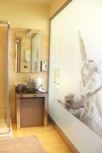 a bathroom with a shower and a sink and a mirror at Ming Hao Hotel in Milan