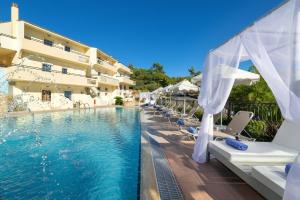 a hotel with a swimming pool and a resort at Pefkos View Apartments in Pefki