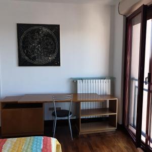 a room with a desk and a table with a chair at Airport Malpensa GALLARATE in Gallarate