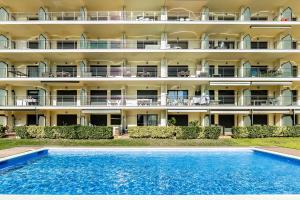 un hôtel avec une piscine devant un bâtiment dans l'établissement the beach milenium, à Roses 6 autres photos