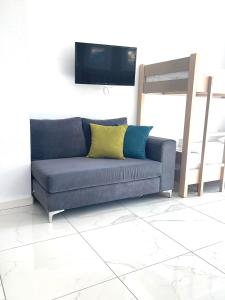a blue couch with two pillows in a living room at Art Studios in Neos Marmaras