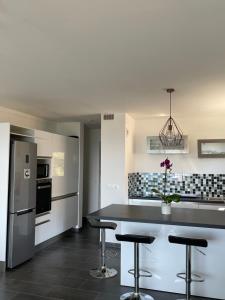 a kitchen with a counter and stools in it at Mango Beach Bandol in Bandol