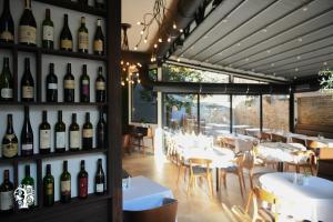 a restaurant with bottles of wine on the wall at Agape Villa Apartments in Novi Sad