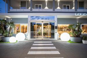 a facade of a building with a glass door at Hotel Kuma in San Giuseppe