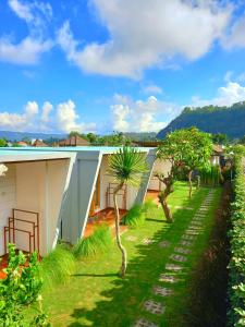 a view of a house with a yard at Batur Caldera Guesthouse in Kintamani