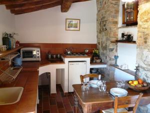 a kitchen with a table and a stove top oven at Podere Patrignone in Castellina in Chianti