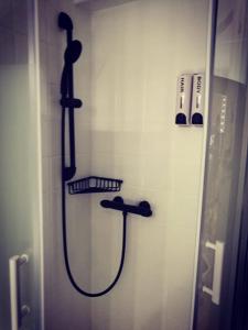 a shower in a bathroom with a hose on a wall at Aix-en-Provence : le boudoir du centre historique in Aix-en-Provence