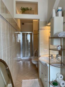 a small bathroom with a sink and a toilet at Casa Gaby in Gravedona +16 photos