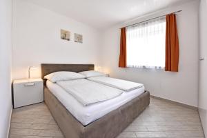 Postel nebo postele na pokoji v ubytování Tomic Apartments