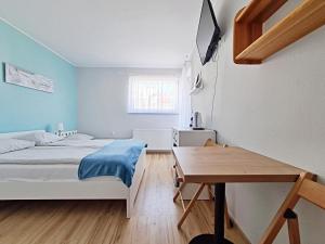 a bedroom with two beds and a table in it at Chatka Morska 3 in Karwia