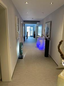 a hallway with blue chairs in a building at Ho(s)tel Ahrbergen in Giesen