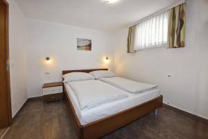 Postel nebo postele na pokoji v ubytování Tomic Apartments