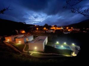 a view of a building at night with lights at Viana do Castelo - Amonde Village Casa P - Conforto Qualidade Natureza in Amonde