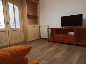 a living room with a flat screen tv on a entertainment center at A Casitta in Furnari
