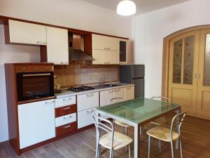 a kitchen with a table and chairs and a stove at A Casitta in Furnari