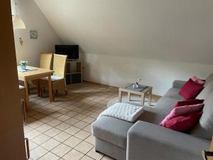 a living room with a couch and a table at Röhrshof in Bispingen