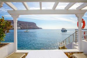 a view of the ocean from a house balcony at Hotel LIVVO Puerto de Mogán in Puerto de Mogán