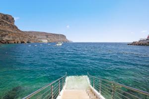 a boat in a large body of water at Hotel LIVVO Puerto de Mogán in Puerto de Mogán