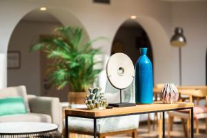 a table with a mirror and a blue bottle at Hotel LIVVO Puerto de Mogán in Puerto de Mogán