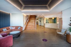 a living room with a couch and a staircase at Hotel LIVVO Puerto de Mogán in Puerto de Mogán