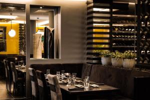 a dining room with a table with wine bottles at Hotel Juliani - Boutique Hotel in St. Julianʼs