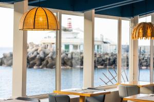 a restaurant with two tables and chairs and windows at Hotel LIVVO Puerto de Mogán in Puerto de Mogán