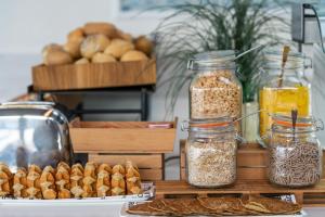 a table topped with jars of food and bread at Hotel LIVVO Puerto de Mogán in Puerto de Mogán