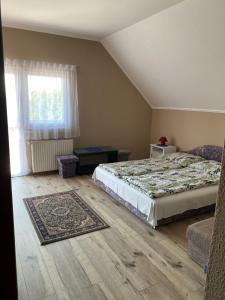 a bedroom with a bed and a rug at Fanni Vendégház in Balatonboglár