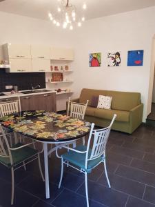 a living room with a table with chairs and a couch at Casa Nonna Anna in Maiori +37 photos