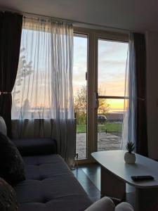 a living room with a couch and a large window at 7 Heaven in Eichenberg