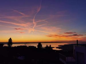 a sunset over a body of water with the sky at 7 Heaven in Eichenberg