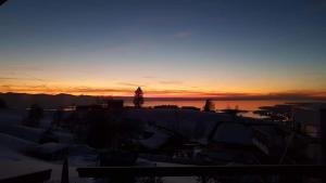 a sunset over a city with snow covered roofs at 7 Heaven in Eichenberg