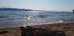 a body of water with a rocky shore with waves at 7 Heaven in Eichenberg